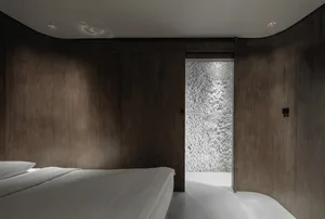 Minimalist bedroom with white bedspread and wooden panel walls