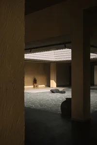 A minimalist lounge area with a concrete roof, focusing on modern, sleek design elements.