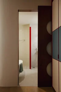 Modern bathroom featuring tile flooring, walnut cabinets, and metallic fixtures.