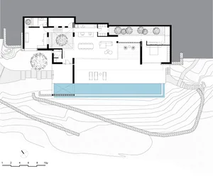 A floor plan of a modern house with glass elements.