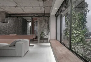 A modern-industrial living room with greenery and concrete wood materials, featuring a contemporary interior design with mini