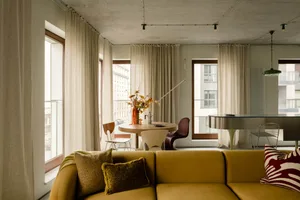 Modern living room with fabric furniture, concrete ceiling, and lighting design