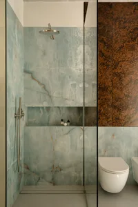 Modern bathroom with marble walls and a sleek design.