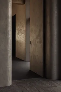 A modern, minimalist interior space with concrete walls and flooring.