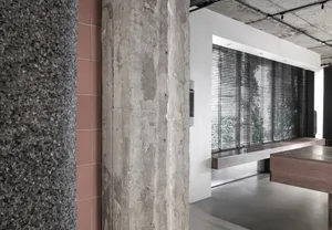 A modern office space featuring concrete columns and a minimalist design aesthetic.