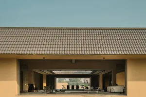 A modern building exterior with a terrazzo-tiled rooftop, large windows, and a spacious outdoor area.