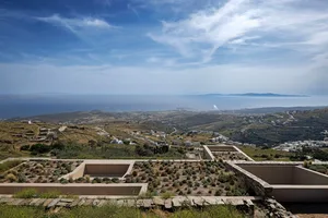 A landscape view of a coastal valley with architecture and natural elements.