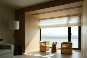 A minimalist living room with wooden frames and a view of the water.