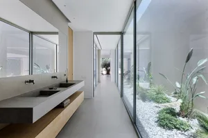 Modern bathroom with concrete sink and steel accents.