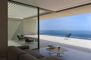 Modern residential living space featuring a concrete and glass design