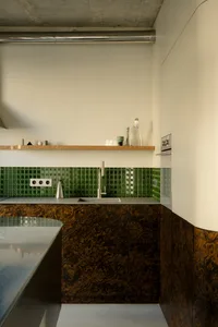 Modern kitchen featuring marble countertops and backsplash