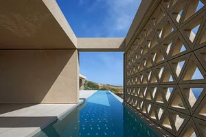 Modern swimming pool constructed of concrete with a geometric design.