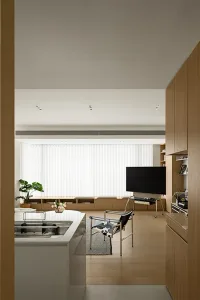 Angular, minimalist residential interior with wood and white finishes.