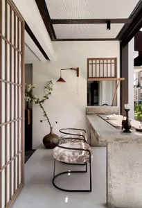 Concrete living room featuring minimalist furniture and modern decor elements.