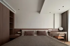A modern bedroom with a wooden headboard and wall, featuring a gray bed and brown accents.