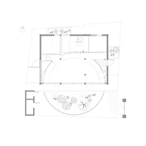 Floor plan of a modern house with a curved central area and a garden view.
