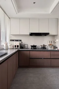 Modern industrial kitchen with wooden cabinets and grey countertops.