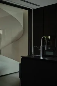 Modern kitchen with metallic fixtures and white wall