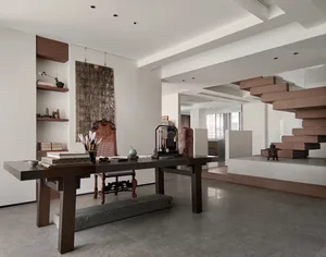 A modernist living room with a concrete staircase and minimalist decor.