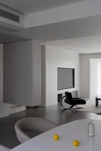 Modern minimalist living room featuring concrete, glass, and steel materials.