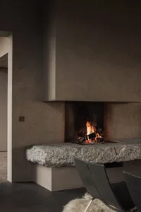 Modern interior design with a corner fireplace made of stone.