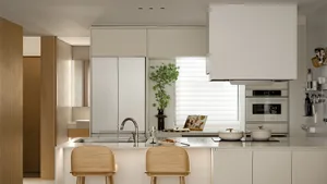 Modern kitchen featuring minimalist white cabinets, stainless steel appliances, and a white marble countertop with a potted p