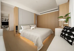 Modern minimalist bedroom featuring wooden furniture, white bedding, and a green plant in a basket