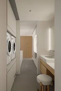 Modern minimalist laundry room featuring white cabinets, oak furniture, and cement floors