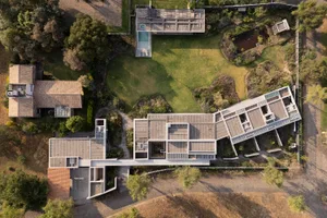 An aerial view of a modern concrete residence layout with a spacious open design.