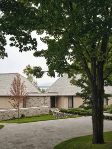 A modern residential space featuring wood accents and a paved driveway.