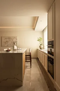 Modern, minimalist residential kitchen featuring marble countertops and flooring