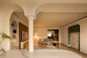 A modern living room featuring a concrete-finish floor, comfortable seating, and stylish decor in a contemporary design.