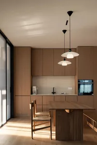 Modern minimalist kitchen with wood cabinets and island.