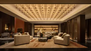 Modern luxury hotel lobby with marble countertops, concrete accents, and luxurious seating arrangements.