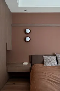 Modern bedroom with wall sconces and wooden furniture