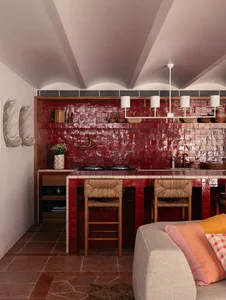 Modern kitchen with red tile backsplash and white countertops.