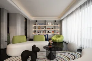 A modern living room with a white sofa, green armchairs, and a black coffee table.