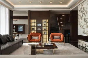 Modern living room featuring luxury furniture with marble, wood, and leather accents.