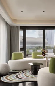 Modern living room with white and green accents, featuring comfortable seating and sleek furniture.