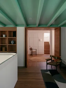 A modern residential interior featuring wooden elements and a minimalist design.