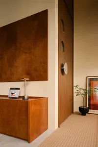 Modern minimalist office space featuring wooden furniture and a sleek design.
