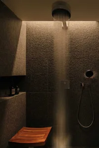 A modern bathroom featuring metallic lighting fixtures