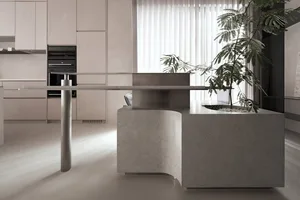 A modern kitchen with minimalist design featuring a concrete countertop and a large window.