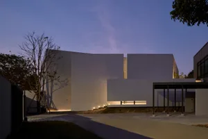 Modern house with a concrete exterior under a twilight sky.