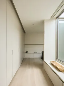 Modern minimalist interior design with wood flooring and minimalist furniture.