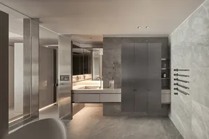 Contemporary minimalist bathroom with grey marble walls and floor, featuring a floating vanity and sleek, modern fixtures.