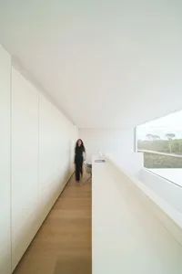 A minimalist office space featuring white materials and an open layout.