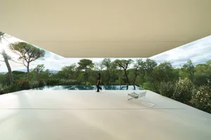 A modern residential space featuring concrete and glass materials.