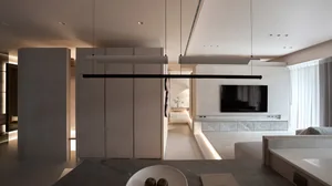 Modern living room with concrete walls and flooring, minimalistic design.