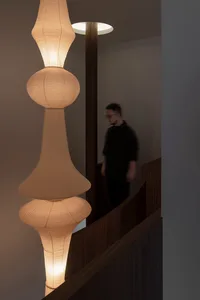 A minimalist paper lamp with a sleek, curved design.